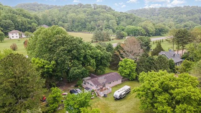 an aerial view of a house with yard