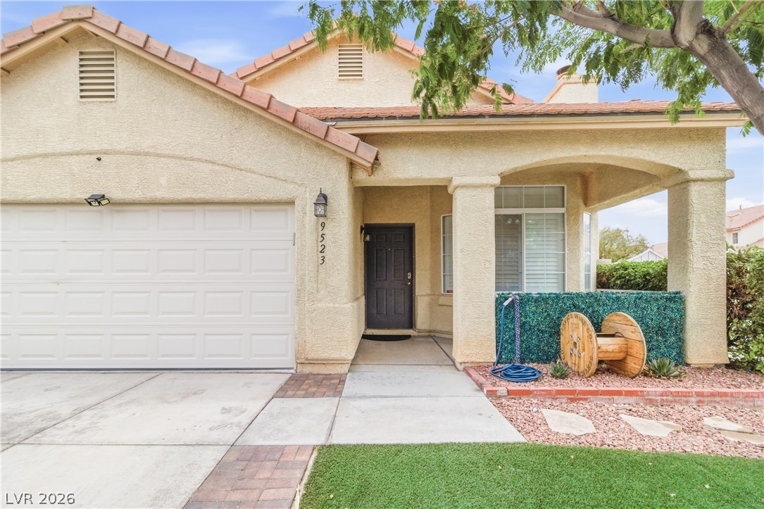 9523 Observer Street Las Vegas, NV 89123 - Photo 4 of 42 A welcoming façade boasts an integrated garage, covered entry, and a charming landscaped front.