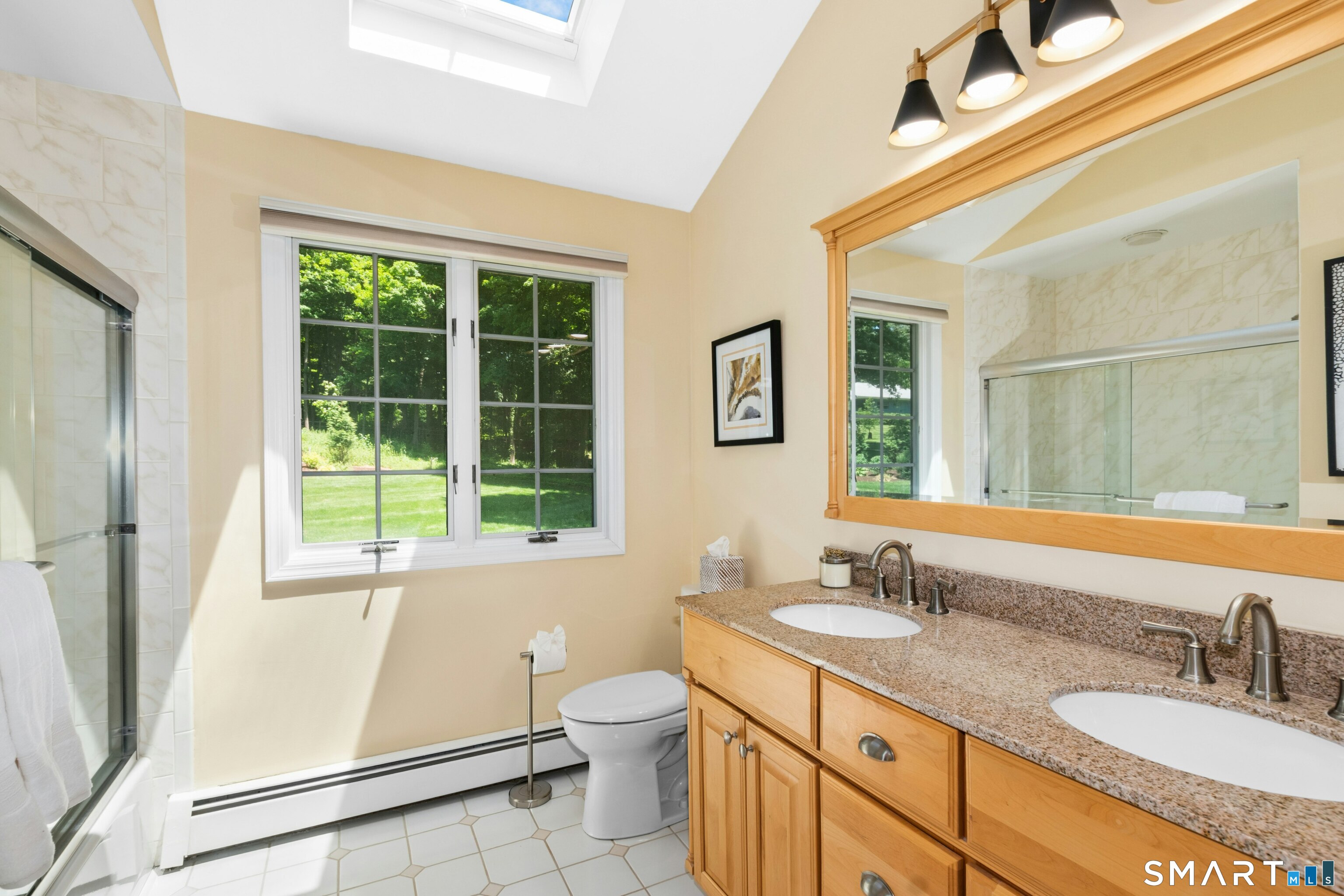 29 Old Farm Road Weston, CT 06883 - Photo 19 of 27 This full bathroom has a double vanity with granite countertop and a tub/shower combination. It also has high vaulted ceilings with a skylight.