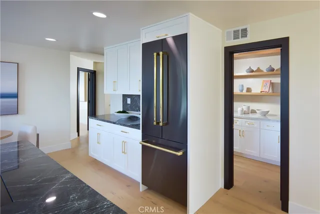 a kitchen with stainless steel appliances granite countertop a stove and a sink