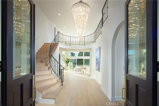 a living room with furniture a fireplace and a large window with garden view