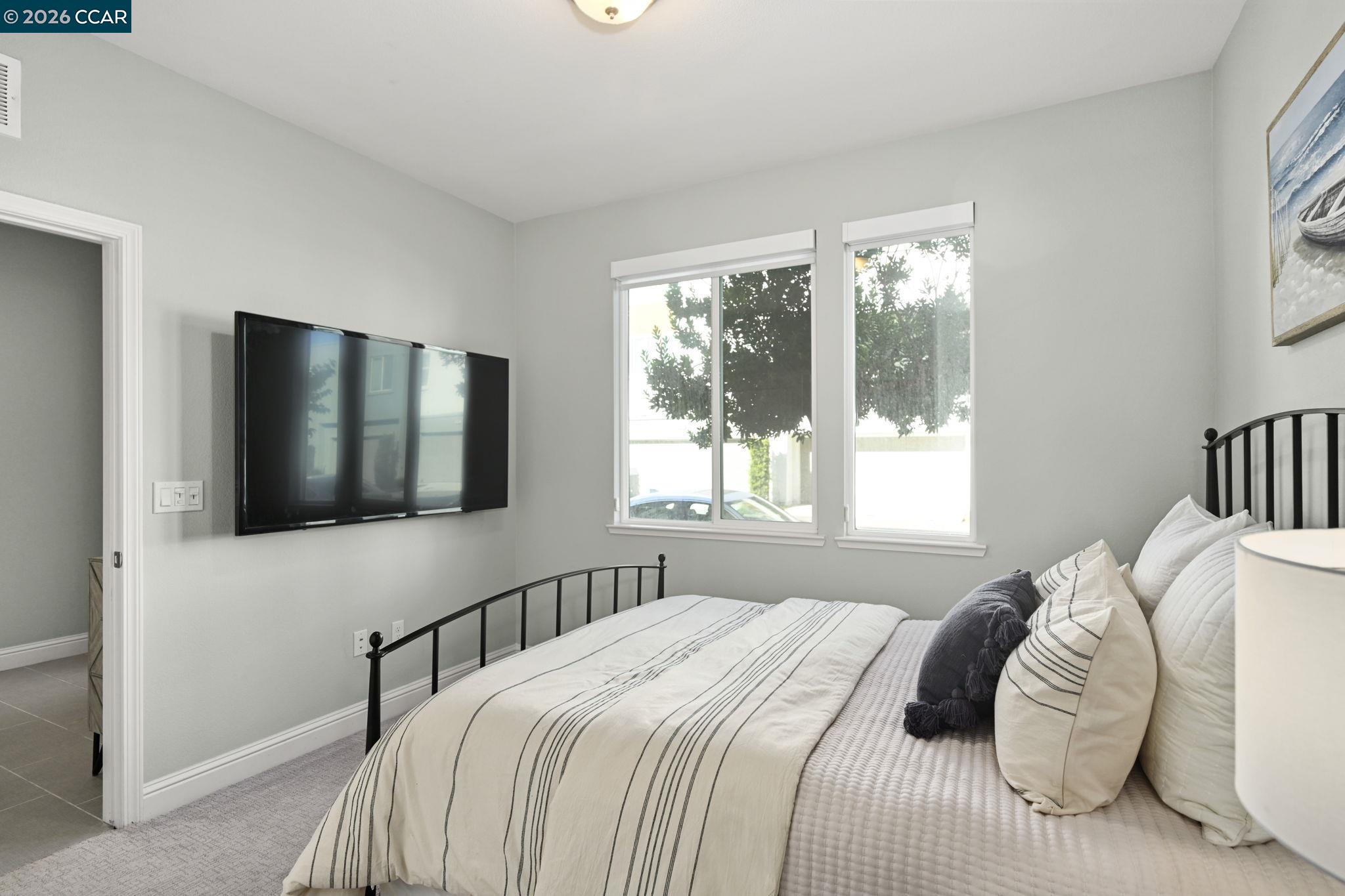 3923 Meridian Street Dublin, CA 94568 - Photo 5 of 39 a bedroom with a bed and a flat screen tv
