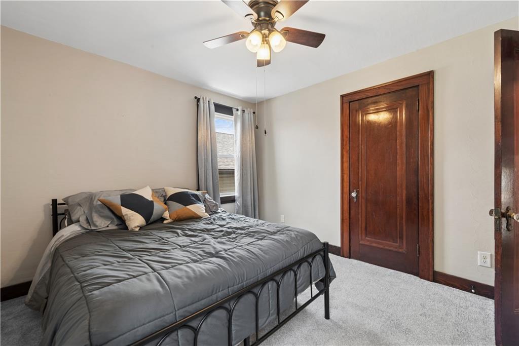 53 Calhoun Avenue Pittsburgh, PA 15210 - Photo 12 of 30 a bedroom with a bed and a chandelier