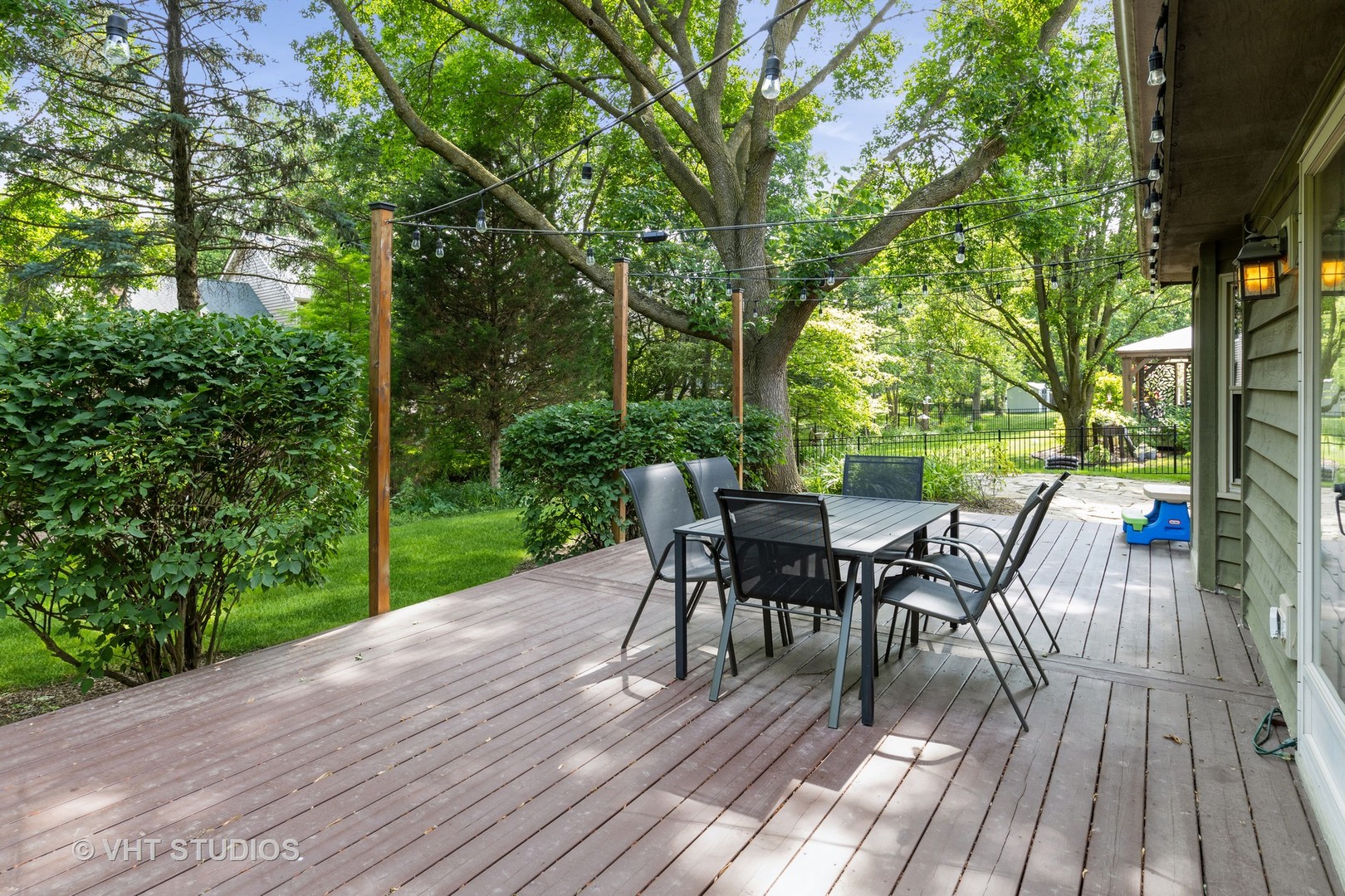 1532 Sequoia Road Naperville, IL 60540 - Photo 3 of 34 a view of a patio with table and chairs and floor to ceiling window with wooden floor