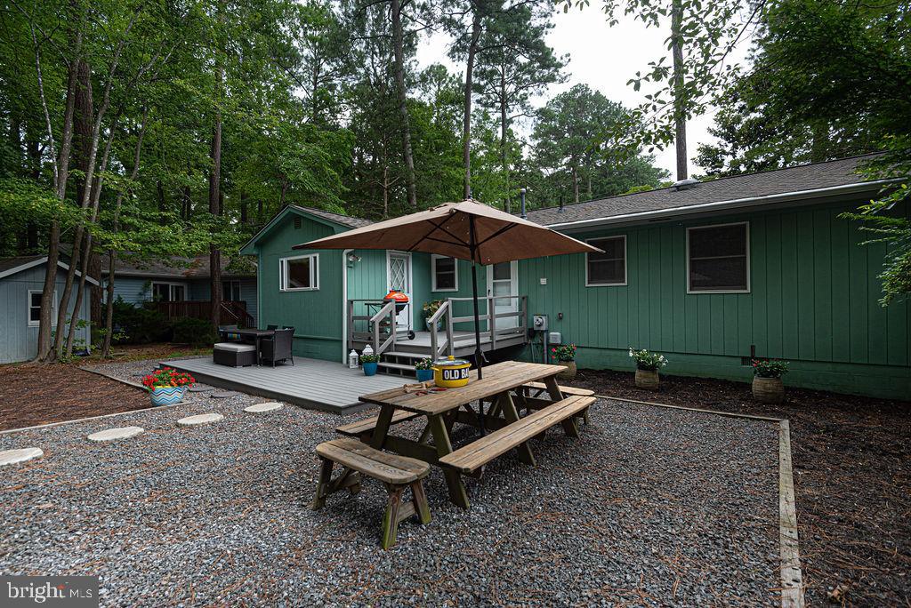 33 Falcon Bridge Road Ocean Pines, MD 21811 - Photo 63 of 71 a view of patio with a table and chairs under an umbrella