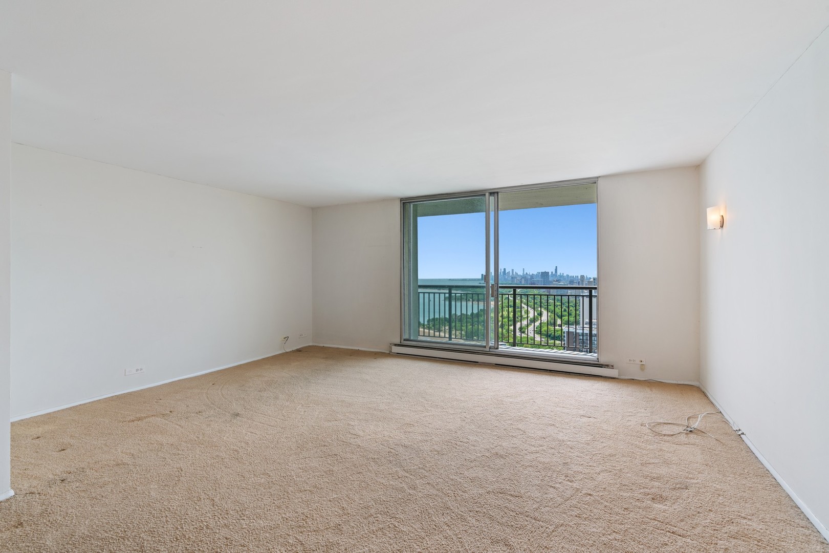 6007 North Sheridan Road, Unit 39C Chicago, IL 60660 - Photo 7 of 19 an empty room with large windows