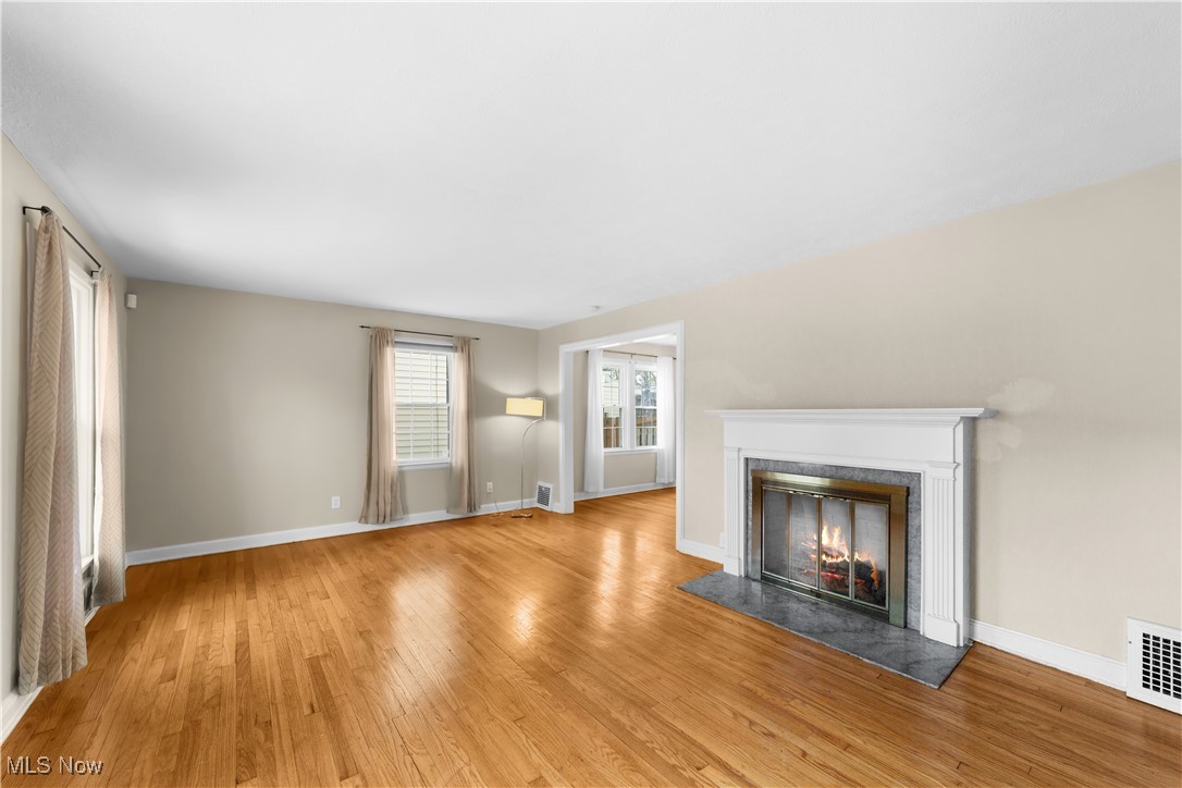 2492 Channing Road Cleveland, OH 44118 - Photo 3 of 14 Unfurnished living room with light wood-type flooring and a tile fireplace