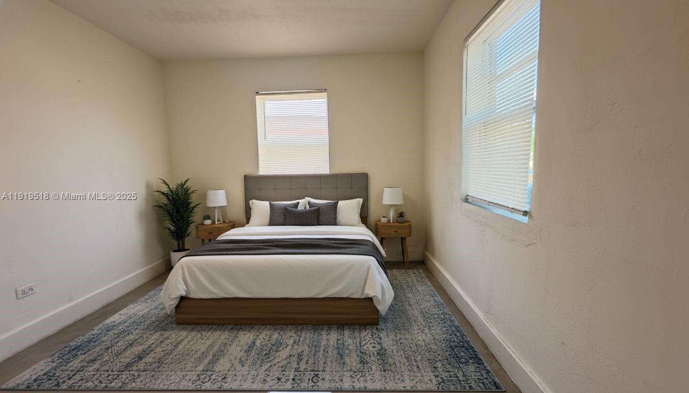 720 82nd Street, Unit 718 Miami Beach, FL 33141 - Photo 4 of 12 a bedroom with a bed and window