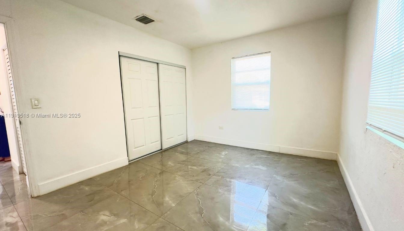 720 82nd Street, Unit 718 Miami Beach, FL 33141 - Photo 9 of 12 an empty room with windows