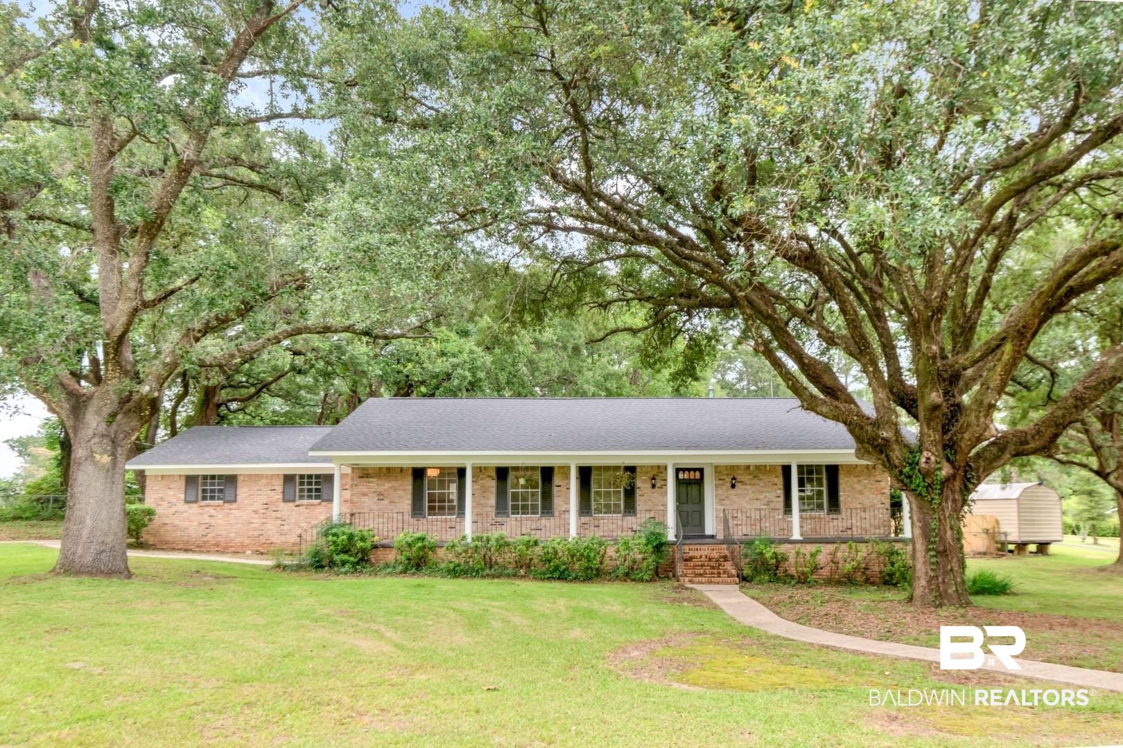 5217 Perin Road Mobile, AL 36693 - Photo 40 of 45 Brick ranch-style residence featuring a dark shingle roof and a covered front porch with white columns