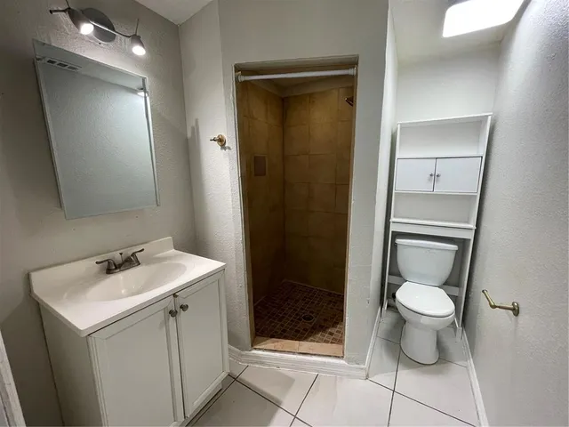 a bathroom with a toilet sink and a shower