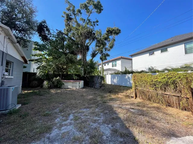 a view of a house with a porch and a yard