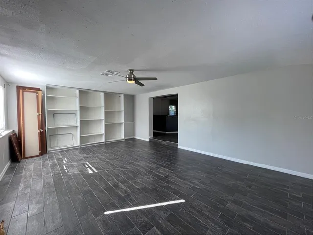 a view of a room with wooden floor and closet