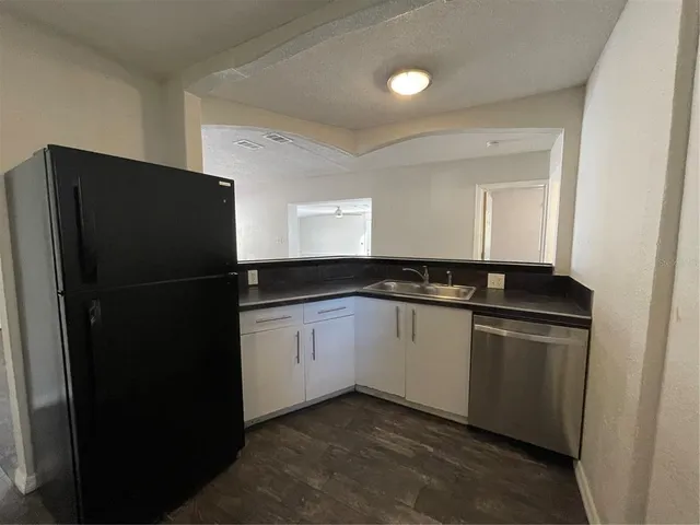 a kitchen with a refrigerator and a sink
