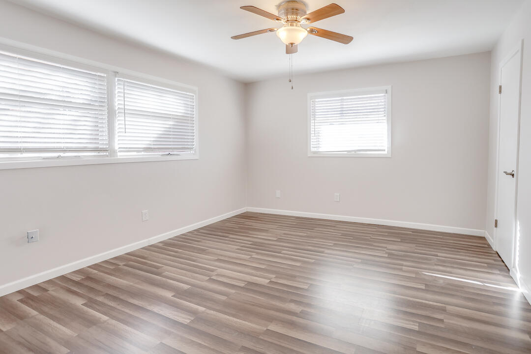 2123 66th Street Lubbock, TX 79412 - Photo 10 of 16 a view of an empty room with wooden floor and a window