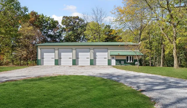 a front view of a house with a garden and trees