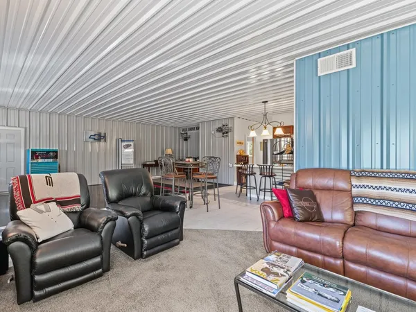 a view of a patio with table and chairs with wooden fence
