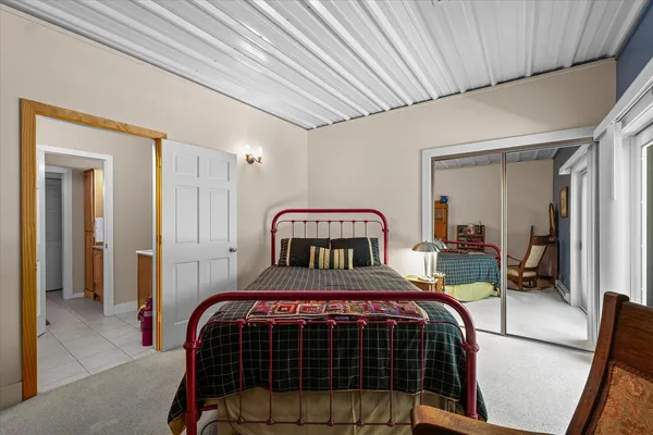 a bedroom with furniture and a wooden floor