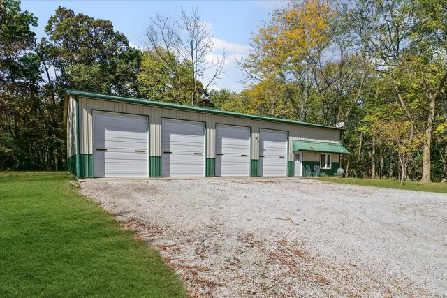 a view of a house with a yard and garage