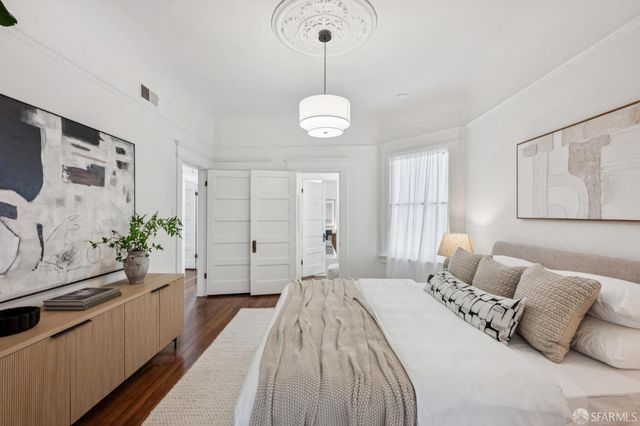 a bedroom with a bed and a chandelier