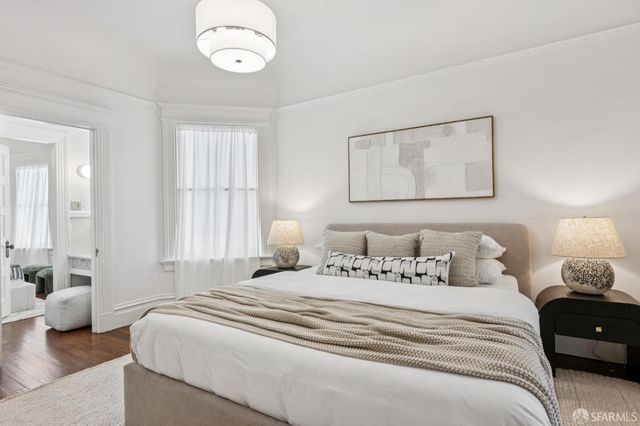 a bedroom with a bed and a large mirror