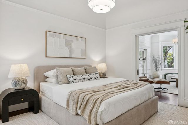 a bedroom with bed and a large window