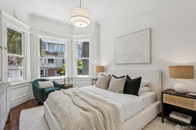 a bedroom with bed and a chandelier