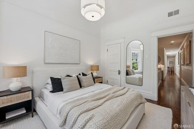 a bedroom with a bed and a chandelier