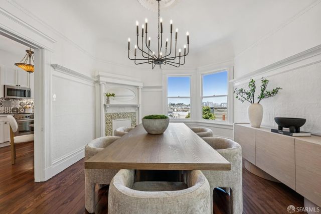 a view of a dining room with furniture and wooden floor