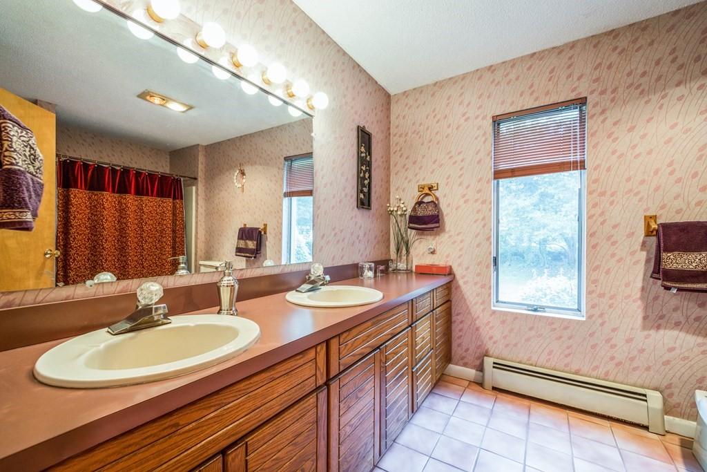 210 Ipswich Road Boxford, MA 01921 - Photo 11 of 33 a bathroom with a double vanity sink a mirror and a