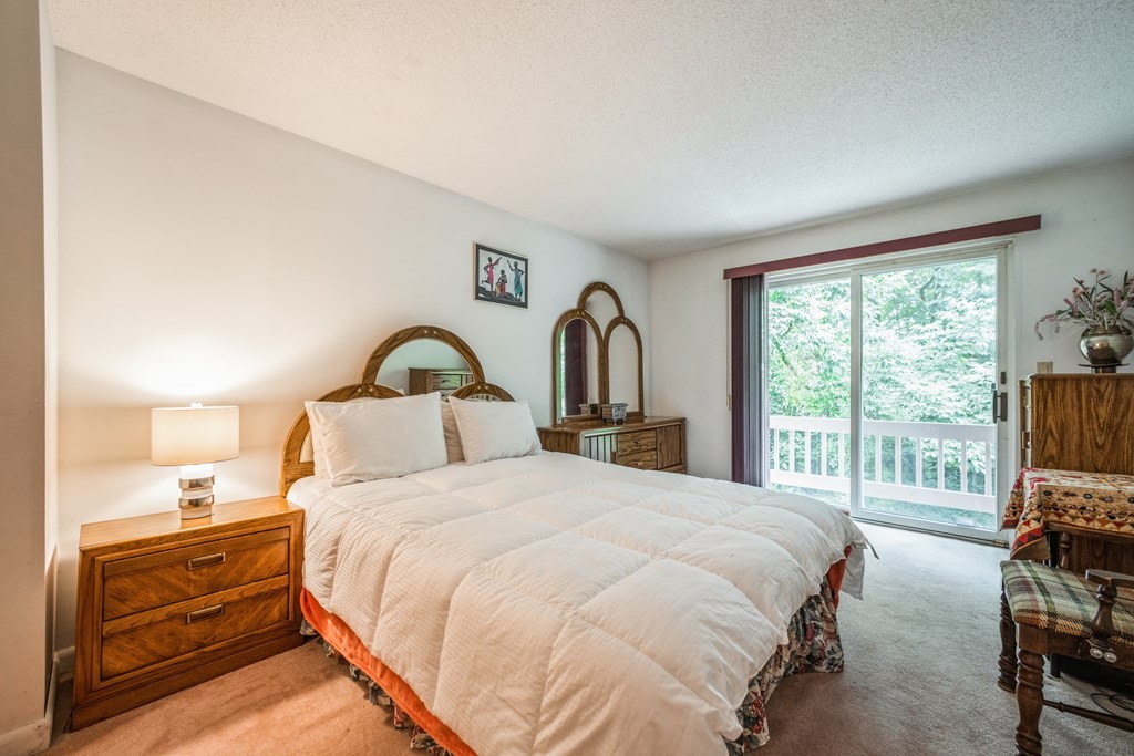 210 Ipswich Road Boxford, MA 01921 - Photo 14 of 33 a bedroom with a bed and a large window with outer view
