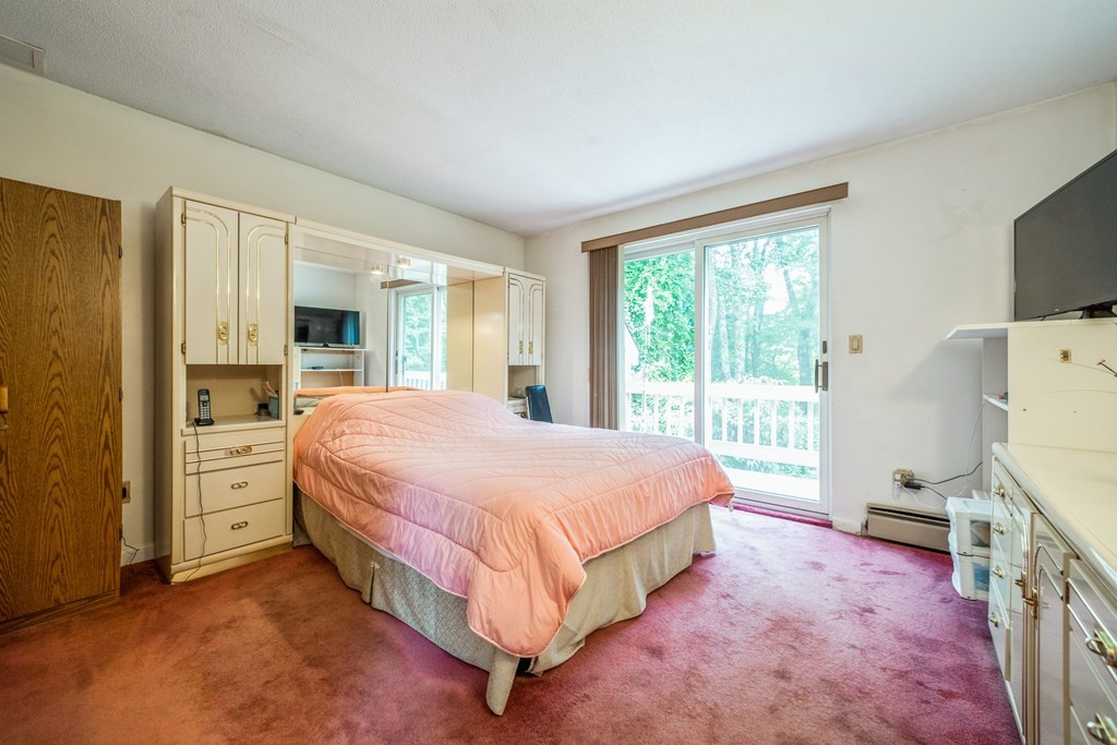 210 Ipswich Road Boxford, MA 01921 - Photo 20 of 33 a spacious bedroom with a bed and a flat screen tv