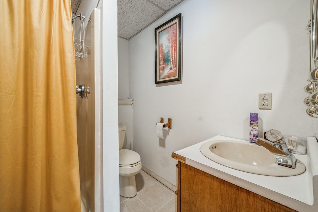 210 Ipswich Road Boxford, MA 01921 - Photo 25 of 33 a bathroom with a sink a toilet and shower curtain