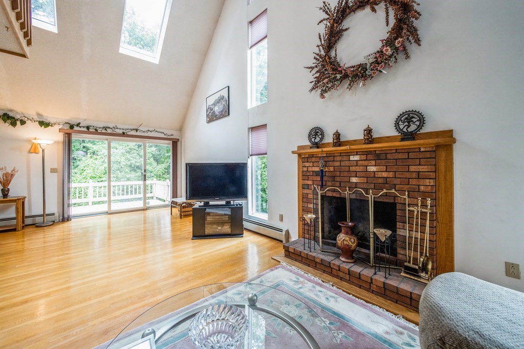 210 Ipswich Road Boxford, MA 01921 - Photo 5 of 33 a living room with furniture large window and a fireplace