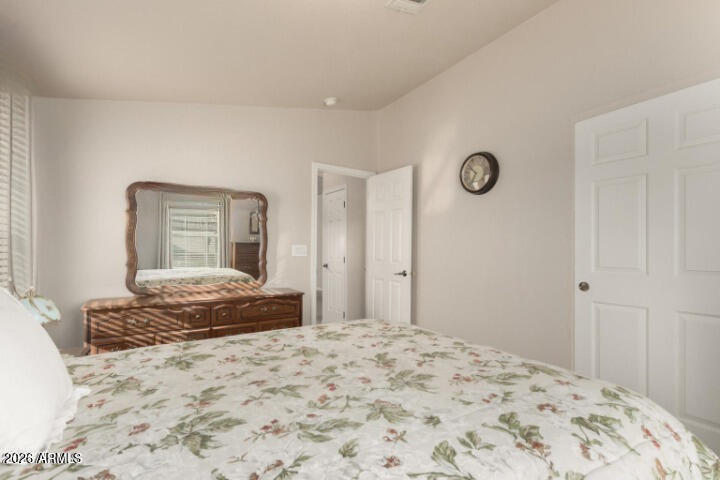 3301 South Goldfield Road, Unit 4086 Apache Junction, AZ 85119 - Photo 13 of 41 a bedroom with a bed and a dresser