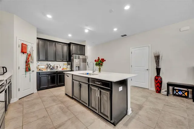 a kitchen with stainless steel appliances a sink and a refrigerator