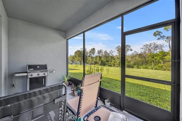 a view of a field with grass and trees