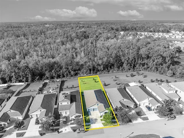 a view of a multi story residential apartment building with a yard