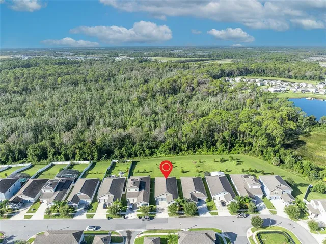 an aerial view of residential houses with outdoor space and swimming pool