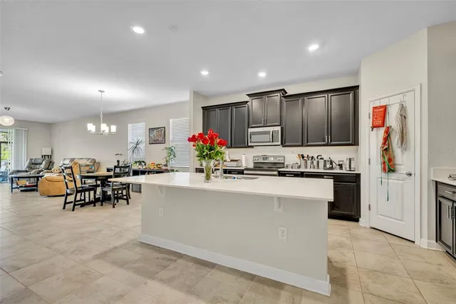 a kitchen with counter top cabinets and refrigerator