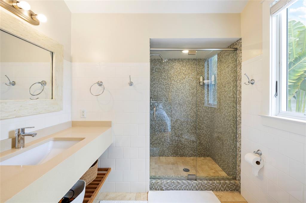 340 Palm Avenue Boca Grande, FL 33921 - Photo 23 of 38 a bathroom with a sink a mirror and a shower