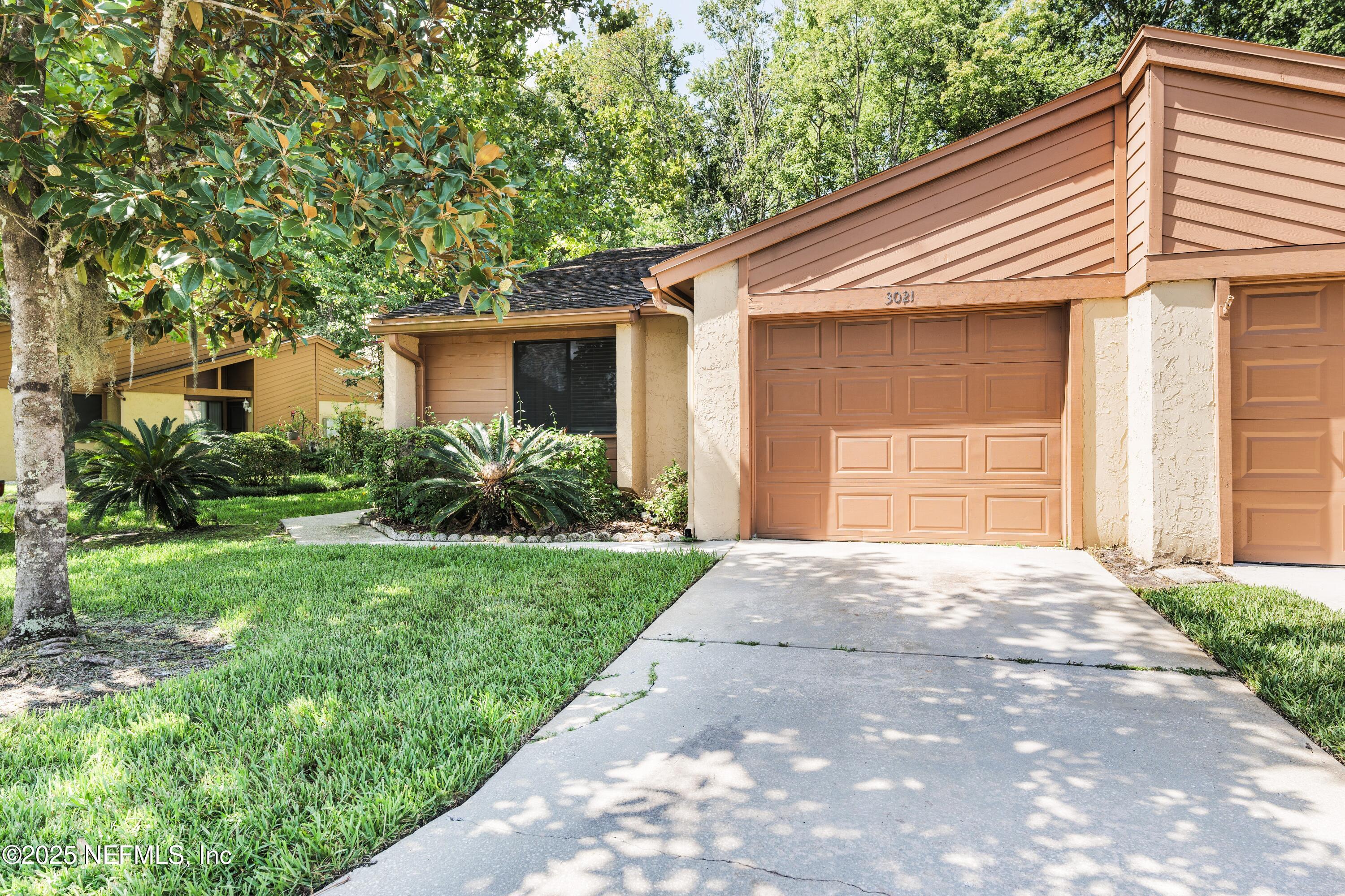 85 Debarry Avenue, Unit 3021 Orange Park, FL 32073 - Photo 1 of 35 a front view of a house with garden