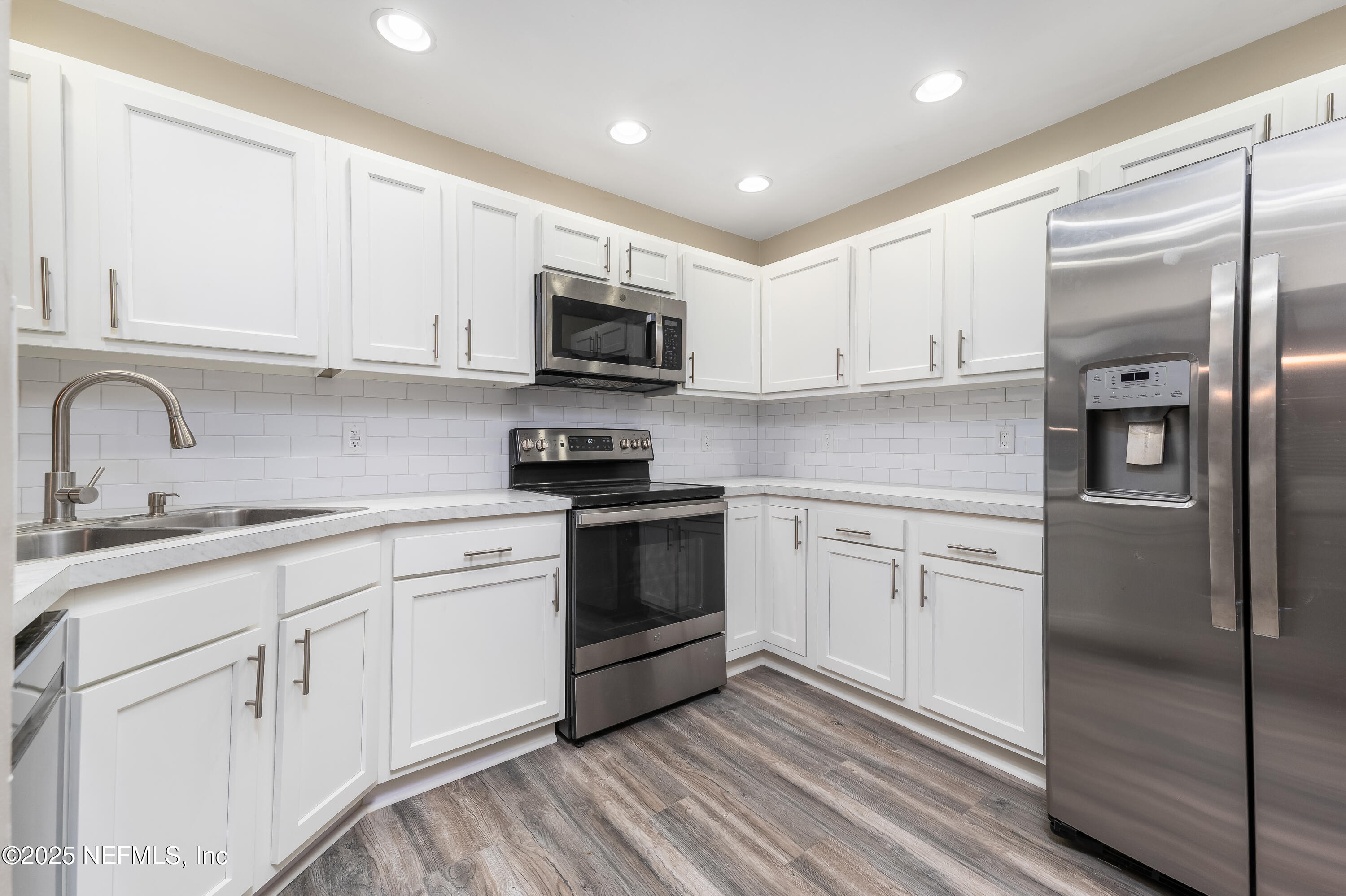 85 Debarry Avenue, Unit 3021 Orange Park, FL 32073 - Photo 12 of 35 a kitchen with cabinets stainless steel appliances and a sink