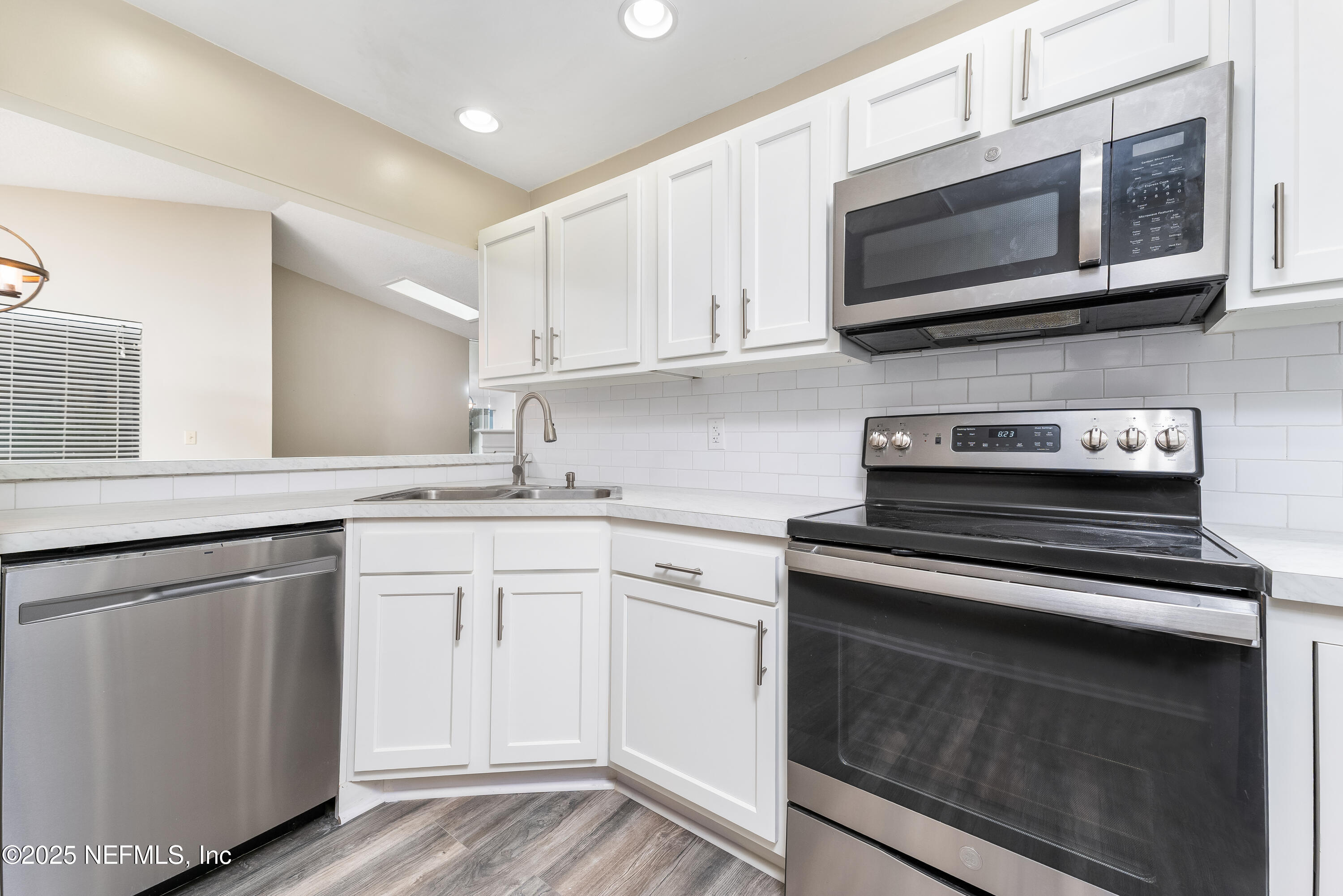 85 Debarry Avenue, Unit 3021 Orange Park, FL 32073 - Photo 13 of 35 a kitchen with stainless steel appliances granite countertop white cabinets a sink and dishwasher