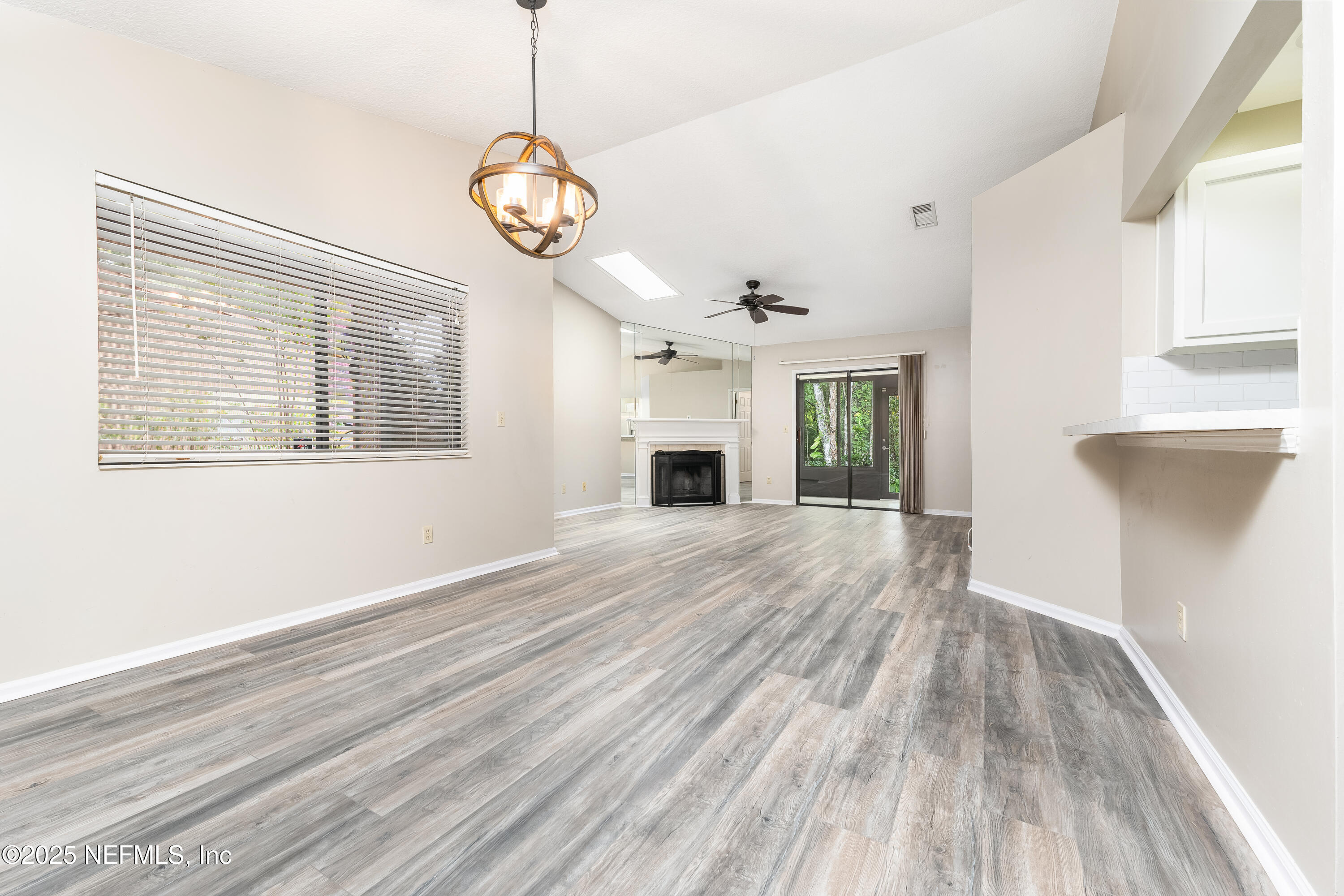 85 Debarry Avenue, Unit 3021 Orange Park, FL 32073 - Photo 18 of 35 a view of an empty room with wooden floor and a window