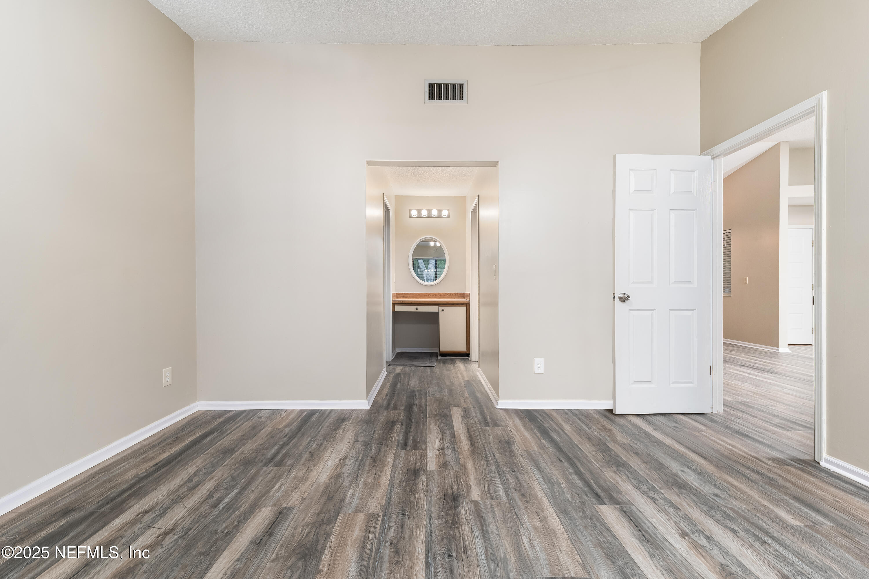 85 Debarry Avenue, Unit 3021 Orange Park, FL 32073 - Photo 20 of 35 an empty room with wooden floor cabinet and windows