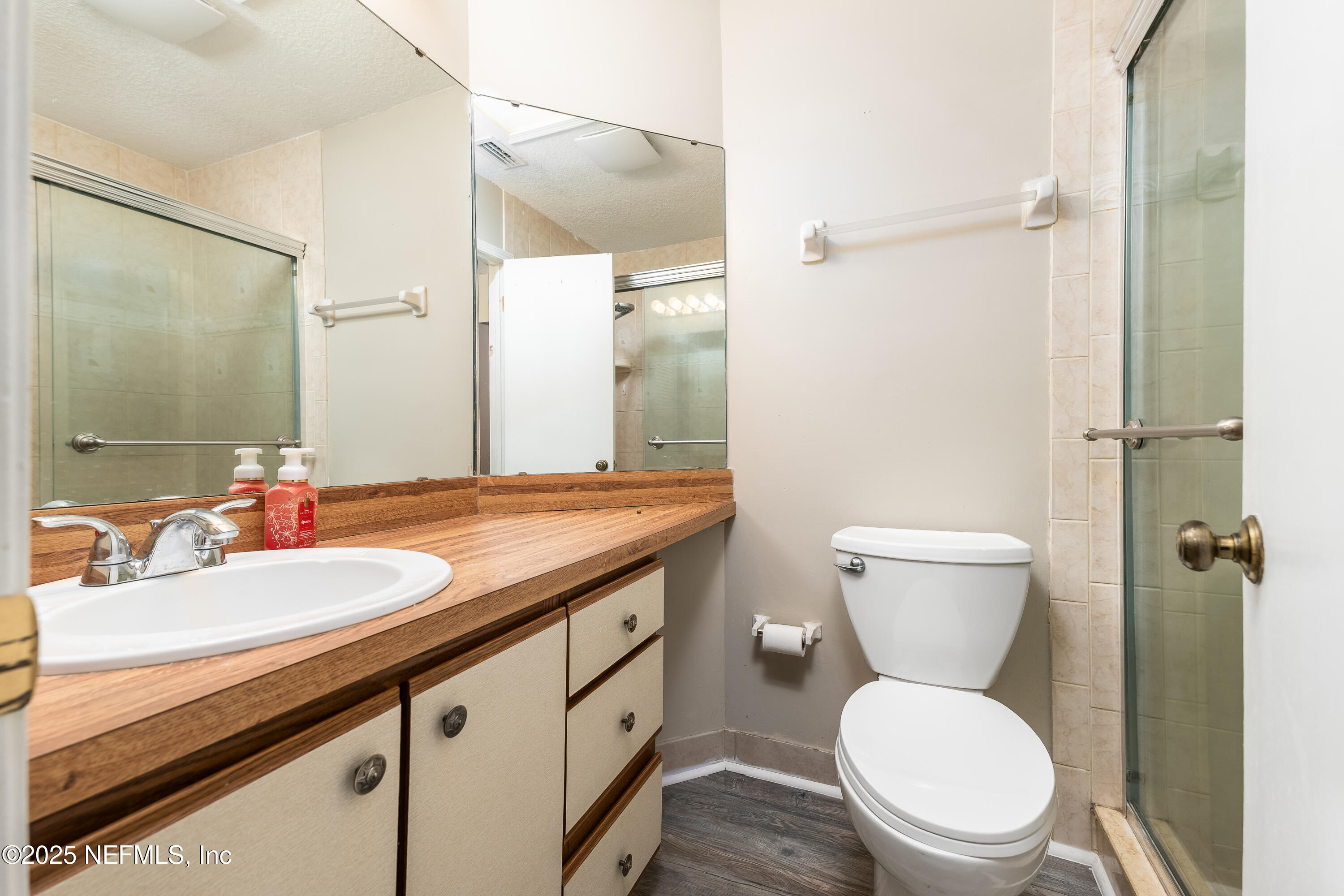 85 Debarry Avenue, Unit 3021 Orange Park, FL 32073 - Photo 23 of 35 a bathroom with a granite countertop toilet sink and a mirror