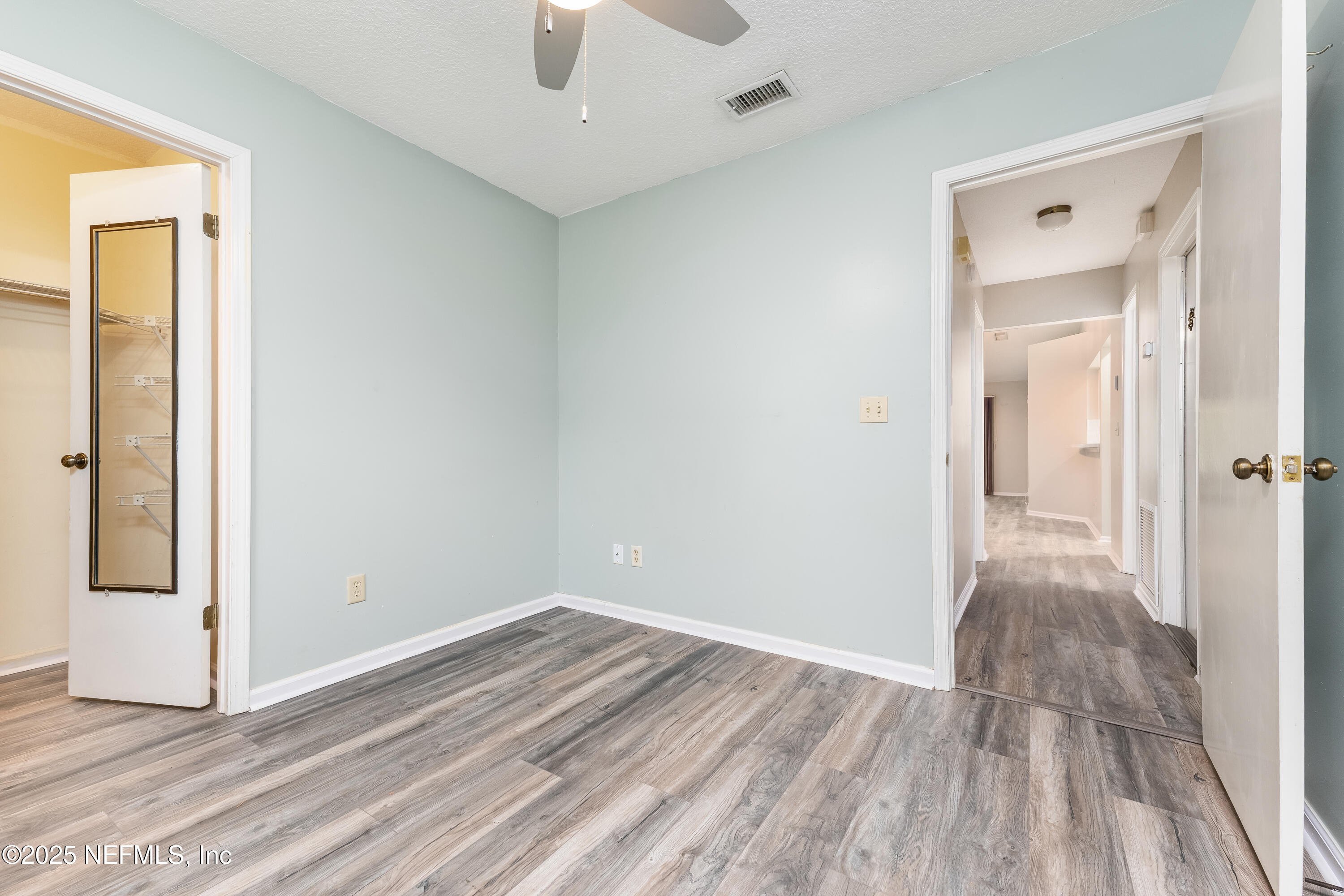 85 Debarry Avenue, Unit 3021 Orange Park, FL 32073 - Photo 27 of 35 a view of a room with wooden floor and a ceiling fan