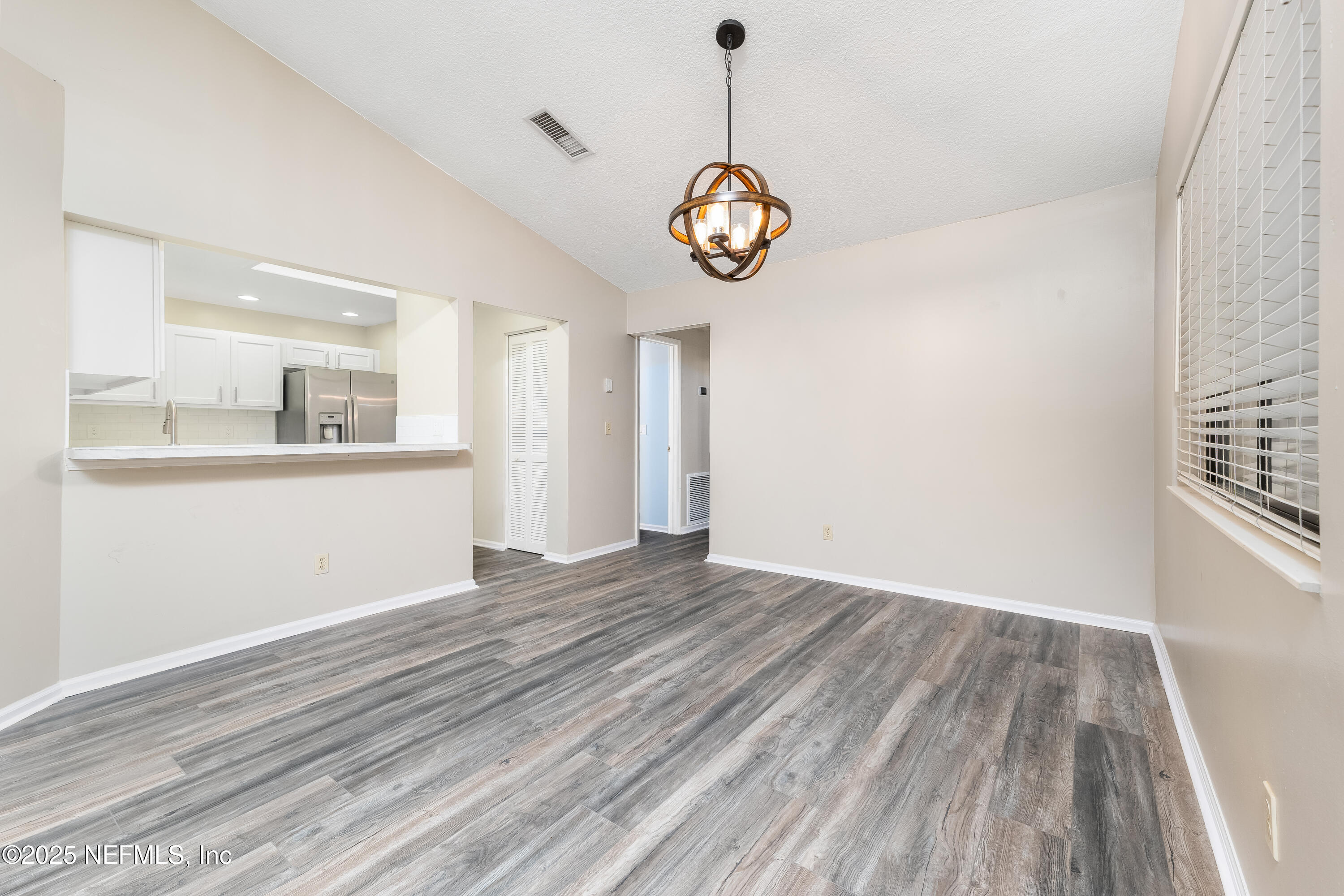 85 Debarry Avenue, Unit 3021 Orange Park, FL 32073 - Photo 10 of 35 an empty room with wooden floor and windows