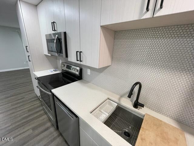 4804 Hoyle Drive, Unit A Raleigh, NC 27604 - Photo 8 of 19 a kitchen with a sink and a stove top oven